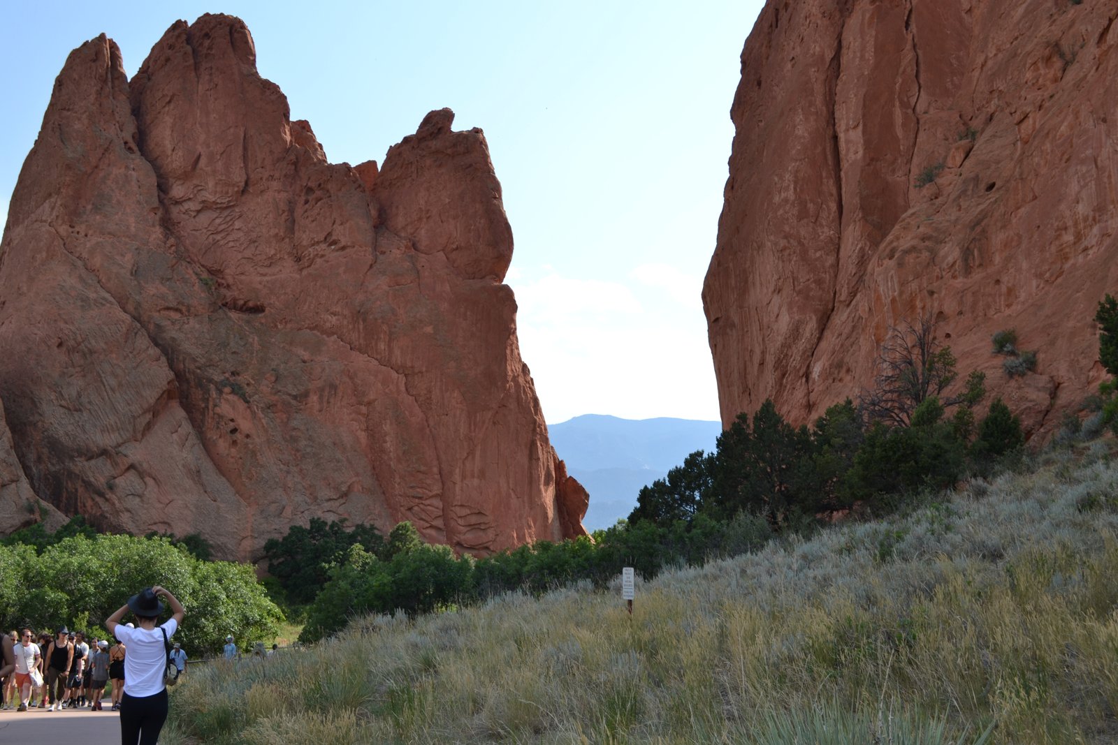 Walking the gap between the towering red rock walls